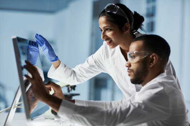 Scientists Working on Computer In  Modern Laboratory stock photo