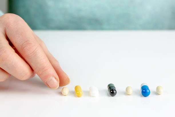 istock Closeup on young woman choosing pills 1093749014