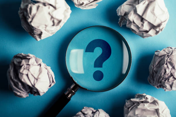 istock Question Mark Magnifying With Crumpled Paper Ball On Blue 1093754236