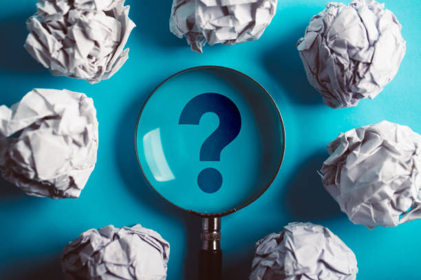 istock Question Mark Magnifying With Crumpled Paper Ball On Blue 1093754248