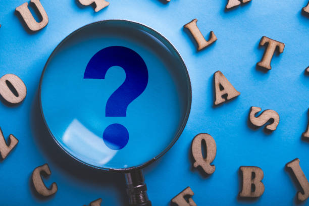 istock Question Mark Magnifying With Wooden Alphabets Around On Blue 1093754268