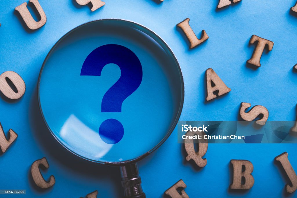 Question Mark Magnifying With Wooden Alphabets Around On Blue Stock ...