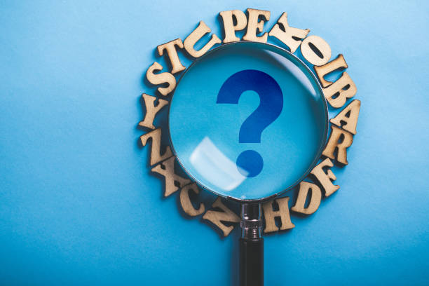 istock Question Mark Magnifying With Wooden Alphabets Around On Blue 1093754278