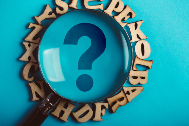 istock Question Mark Magnifying With Wooden Alphabets Around On Blue 1093754288