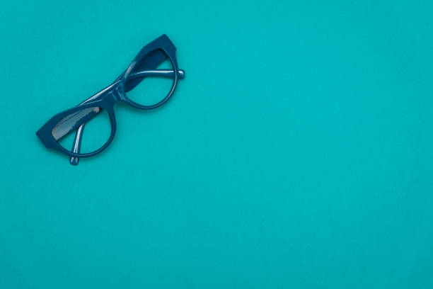 istock Top view flat lay, modern blue eye glasses on pastel paper background 1093763434
