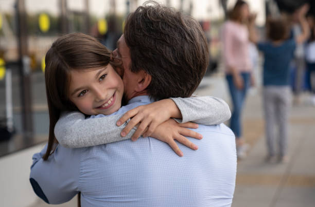 istock Daughter hugging her father at the airport 1093764874