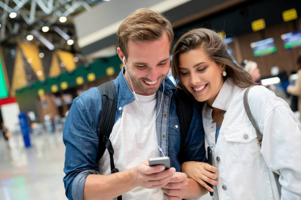 istock Couple at the airport using a cell phone 1093765206