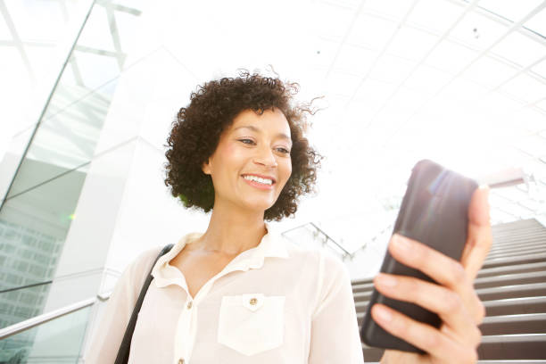 istock beautiful older woman looking at mobile phone 1093765716
