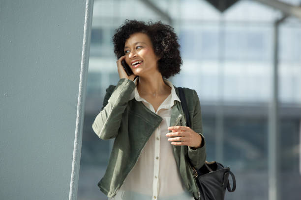 istock smiling african american woman talking on cellphone 1093765722