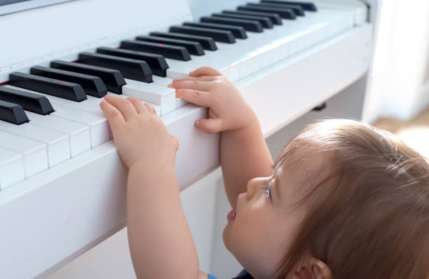 istock Toddler boy playing the piano 1093767028