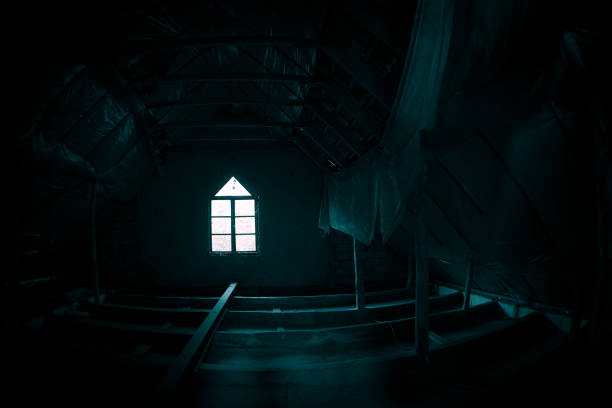 Mysterious mood created by white light in the window, subtle illuminated floor and total darkness around or Empty room with dramatic light entering the window.