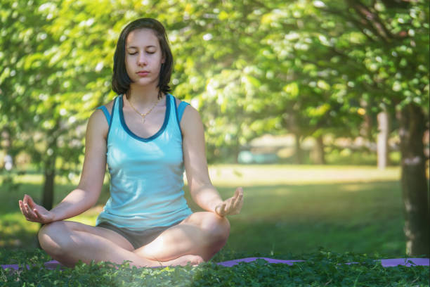 istock caucasian female having yaga and meditation in park 1093802012