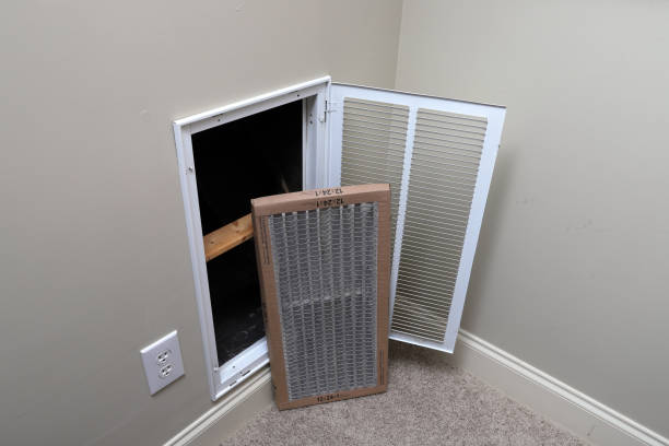 Replacing dirty air filter for air conditioner system maintenance stock photo