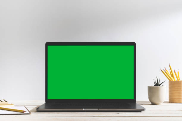 istock Chroma key green screen laptop on table. 1093817454