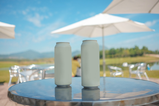 Beverage cans on the table Parasols and natural views