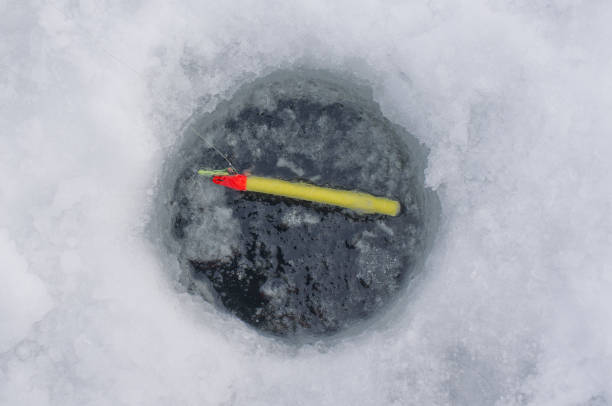 istock Ice fishing hole with bobber 1093825962