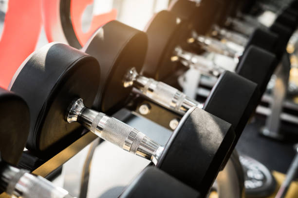 istock Rows of dumbbells on a rack in a gym 1093836644