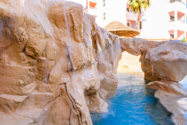 istock Small waterfall with turquoise water in the hotel pool 1093841782