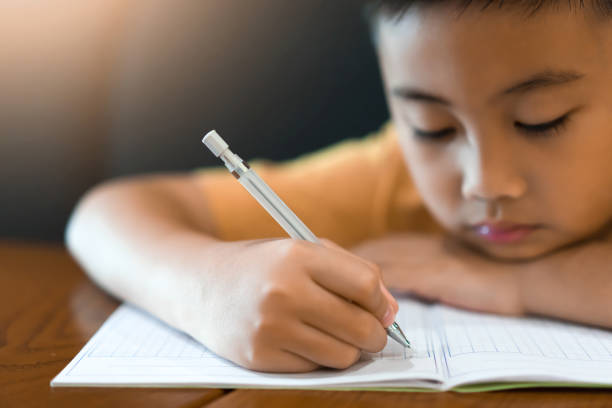 istock Little boy hand is writing homework at home.Education concept 1093841926