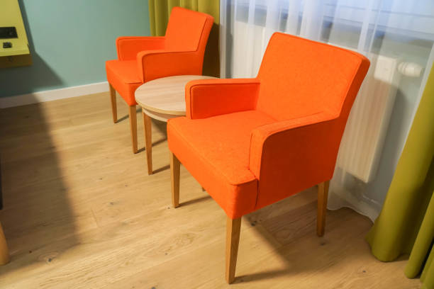 istock bright orange armchair in hotel bedroom 1093842336