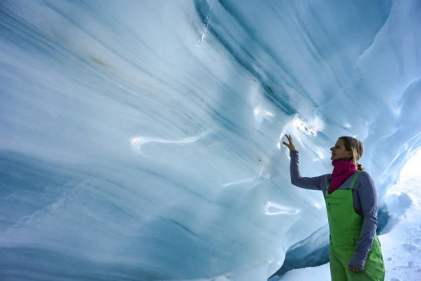 istock Woman exploring a glacial ice cave 1093855824