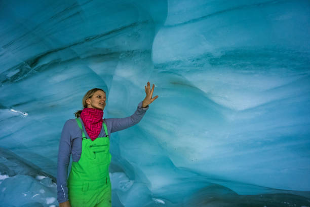 istock Woman exploring a glacial ice cave 1093855832