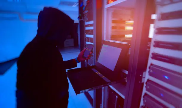Hacker will hacking and steal data information in the server room of technology data center is concept