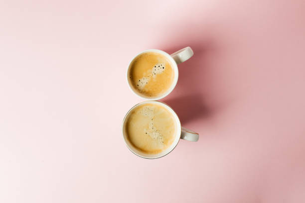 istock Couple white cups with coffee on pink pastel background, 8 march celebration minimal concept. Copy space. Top view 1093860428
