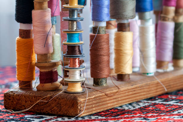 istock Sewing multicolored threads of soft pastel vintage colors on spools. Sewing tailor related accessories. 1093865098