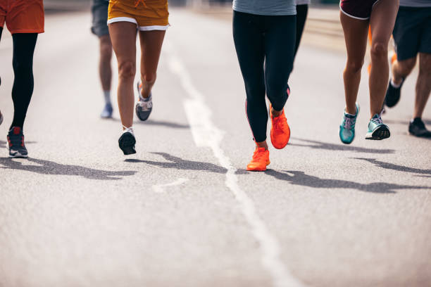istock Large group of unrecognizable marathon runners having a race on the road. 1093869624
