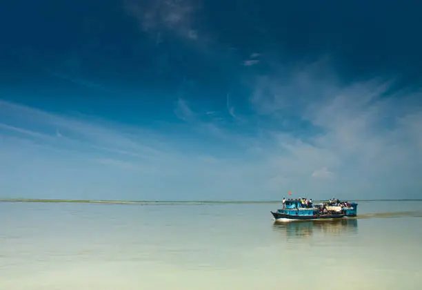 Photo of BRAHMAPUTRA RIVER, ASSAM, INDIA, April 2011, Locals with Ferry boat for transportation