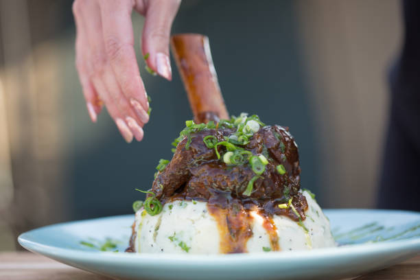 istock Sticky delicious lamb shank served on creamy mashed potatoes and parsley 1093870412