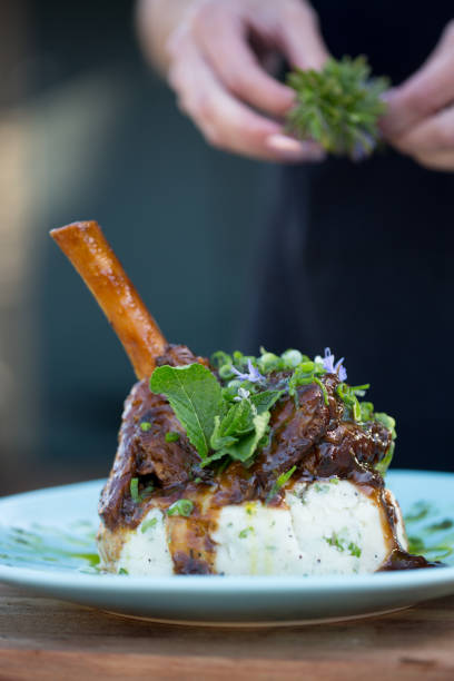 istock Sticky delicious lamb shank served on creamy mashed potatoes and parsley 1093871046