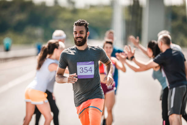 istock Happy man running a marathon race on the road. 1093871166