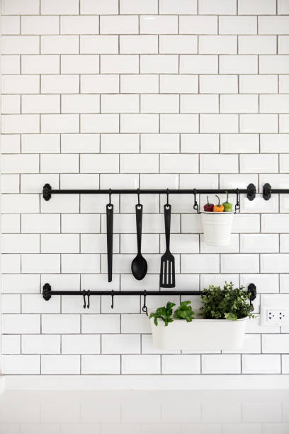 kitchen utensil hanger on white brick wall