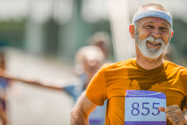 istock Happy senior athlete running a marathon race. 1093871766