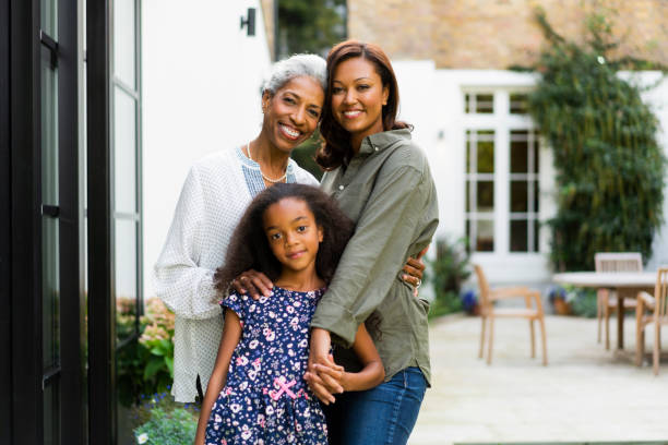 istock Smiling multi-generation females standing in yard 1093875250