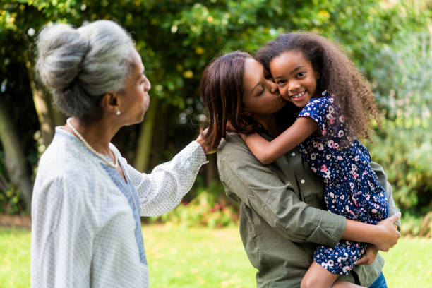 istock Multi-generation females standing in back yard 1093875294