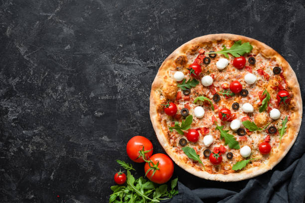 istock Tasty pizza with tomatoes and mozzarella on black background 1093875578