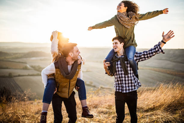 istock Young carefree couples having fun during autumn day on a hill. 1093880586