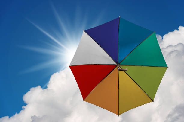 istock Multicolor umbrella flying in the sky 1093881042