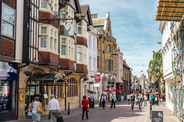 Street View Of Canterbury In England Canterbury, United Kingdom - June 24, 2018: People strolling down the streets of Canterbury on a sunny day in England. canterbury england photos stock pictures, royalty-free photos & images