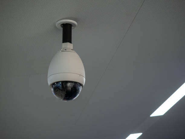 istock White circular surveillance camera on ceiling in a public setting attached to white ceiling 1093883926