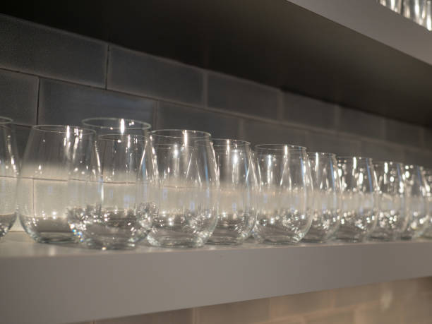 istock Shelf with multiple rows of small wine glasses in kitchen 1093883982