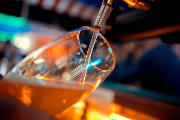 istock bartender pours beer from the tap 1093886358