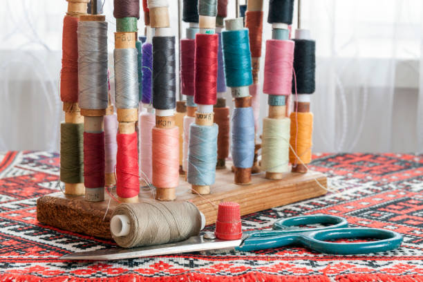 istock Sewing multicolored threads of soft pastel vintage colors on spools. Sewing tailor related accessories. 1093888538