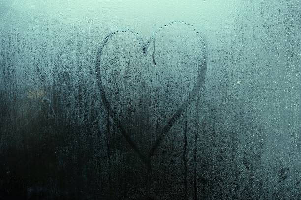 istock Heart shape on wet glass 1093888848