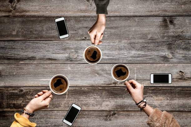 istock People hands drinking coffee on wooden table 1093888932