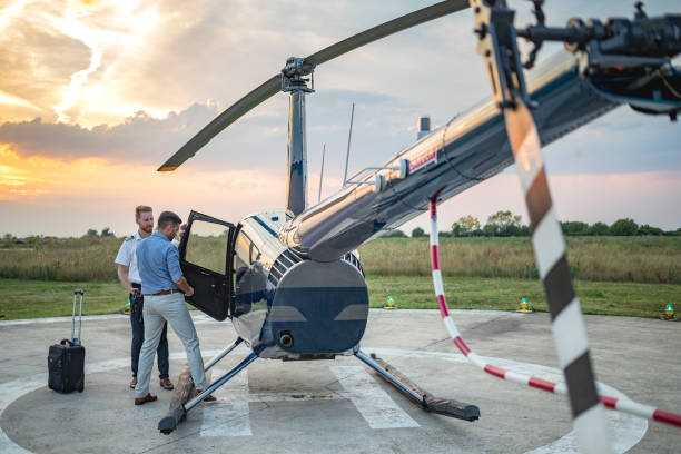 istock Helicopter pilot opening door for passenger boarding 1093892006