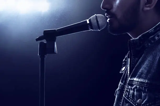 Photo of Singer singing with microphone